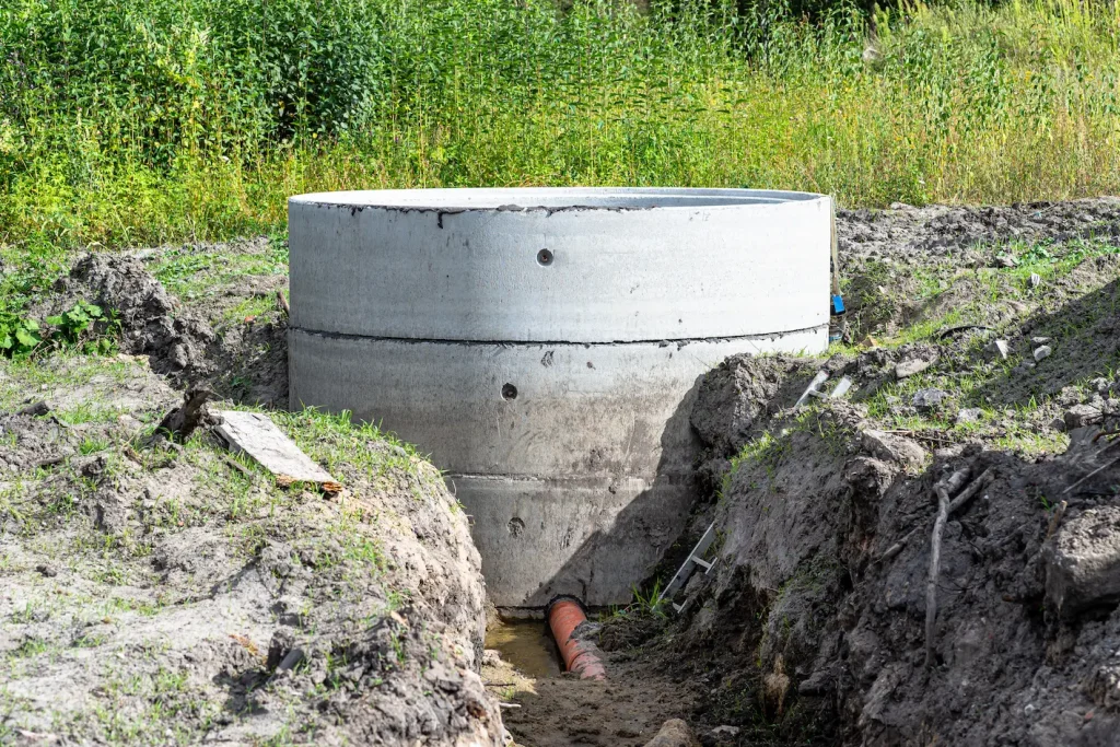 Side view of a septic tank being repaired.