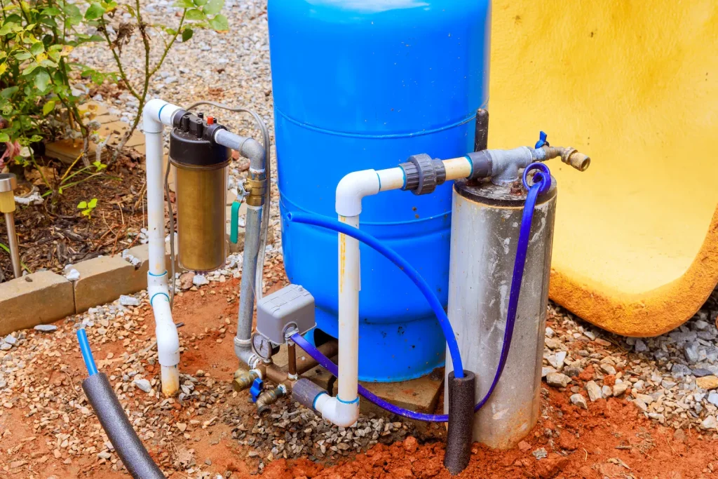 Well pump being installed outside of a house.